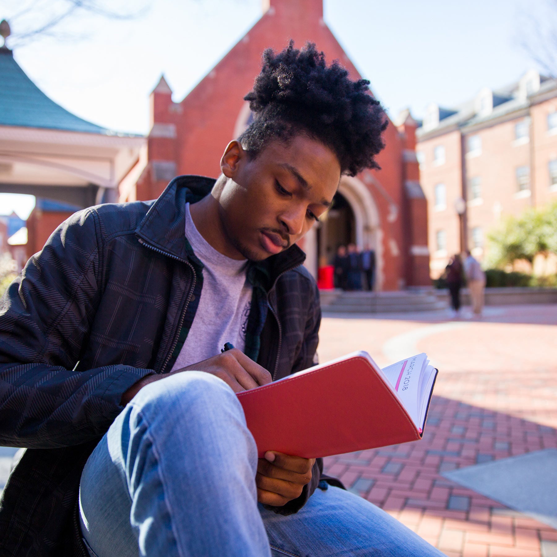 Emmanuel reads in Dahlgren Quad