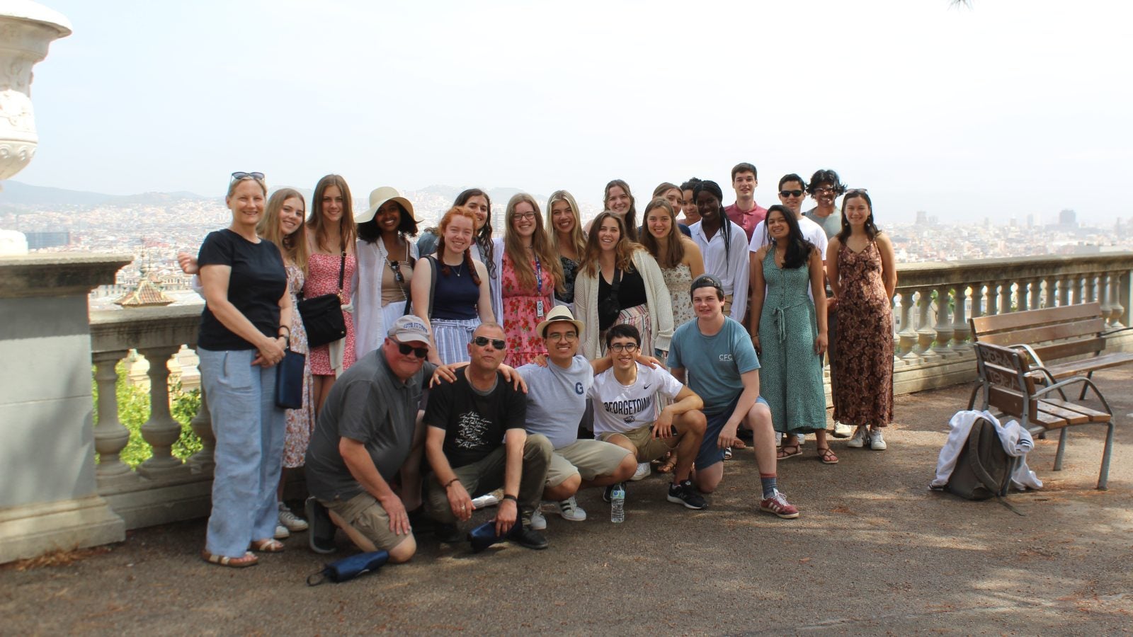 A group of young people standing by a railing in Spain outside