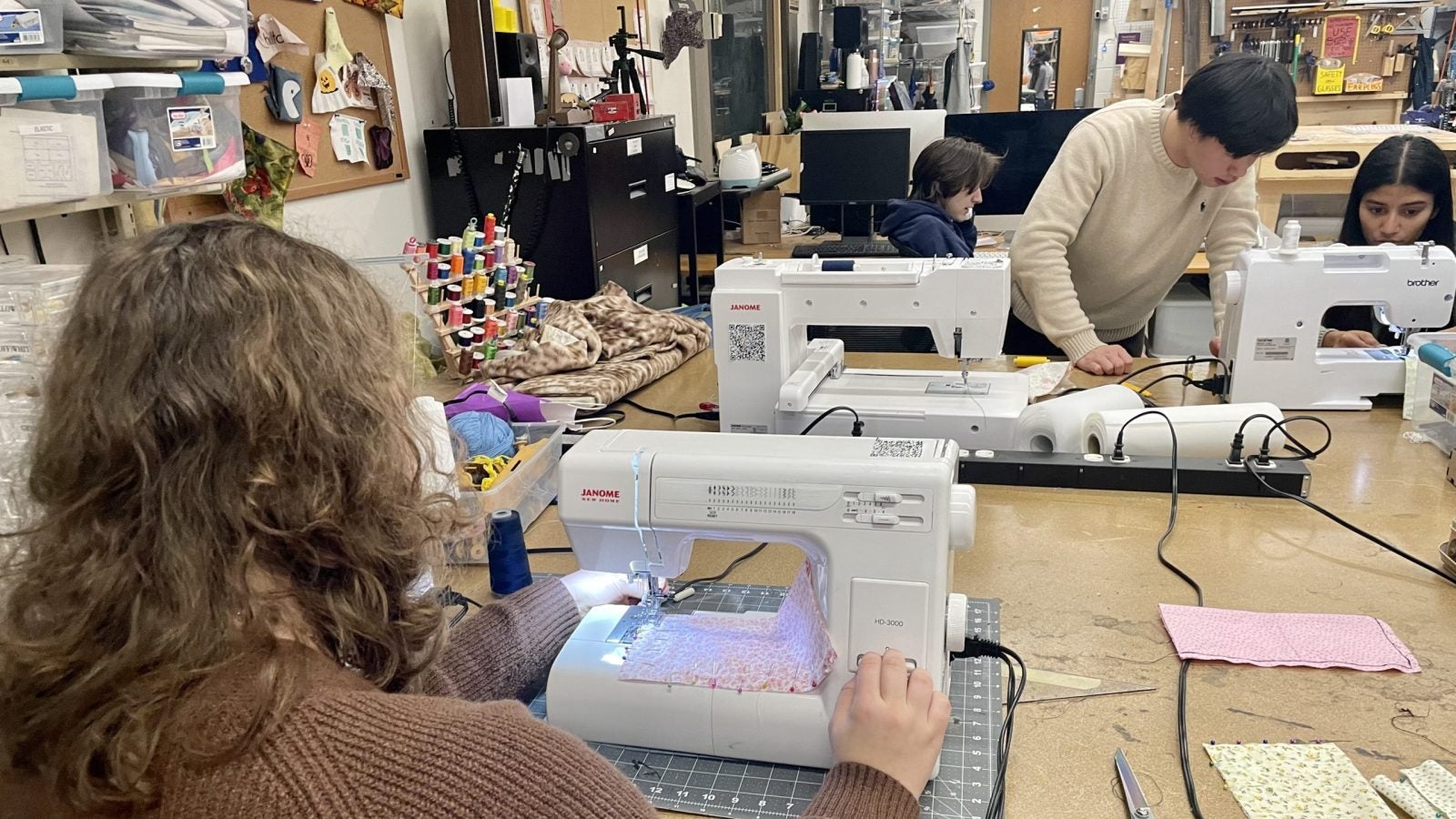 Students diligently sewing at the Makerhub