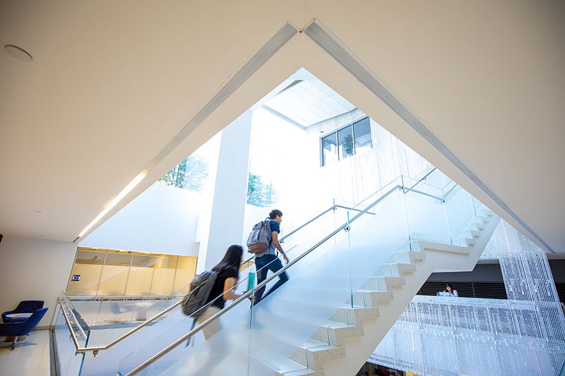 Students walk through the School of Continuing Studies lobby